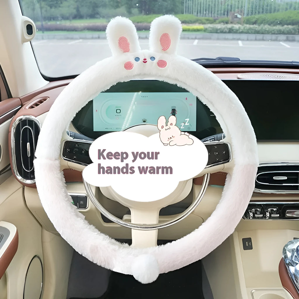 Plush winter steering wheel cover with embroidered bear design, shown on a car steering wheel.