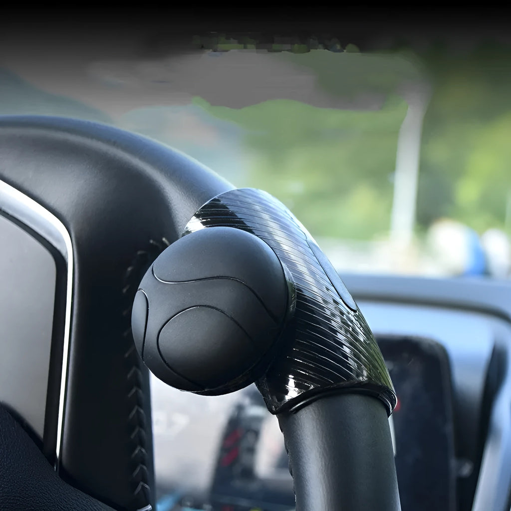 Black and blue silicone steering wheel assist ball showing round design for single-handed steering control.