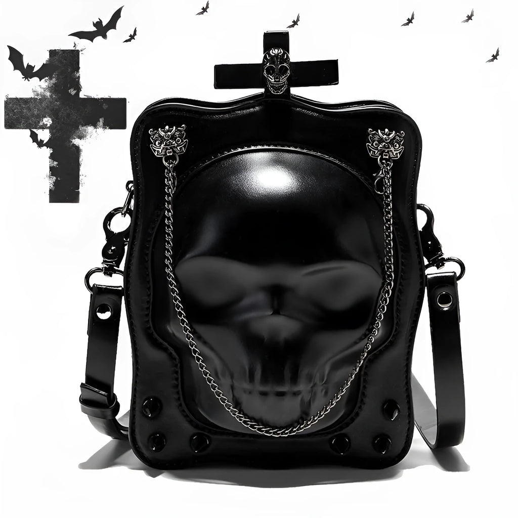 Black mini square crossbody bag with embossed skull design, metal rivets, chain strap, and top zipper.