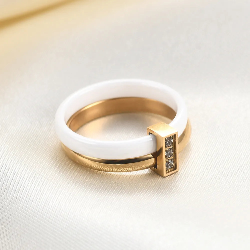 Close-up of a women's black ceramic ring with a geometric stitch pattern on a 6mm wide band, showcasing glossy finish.