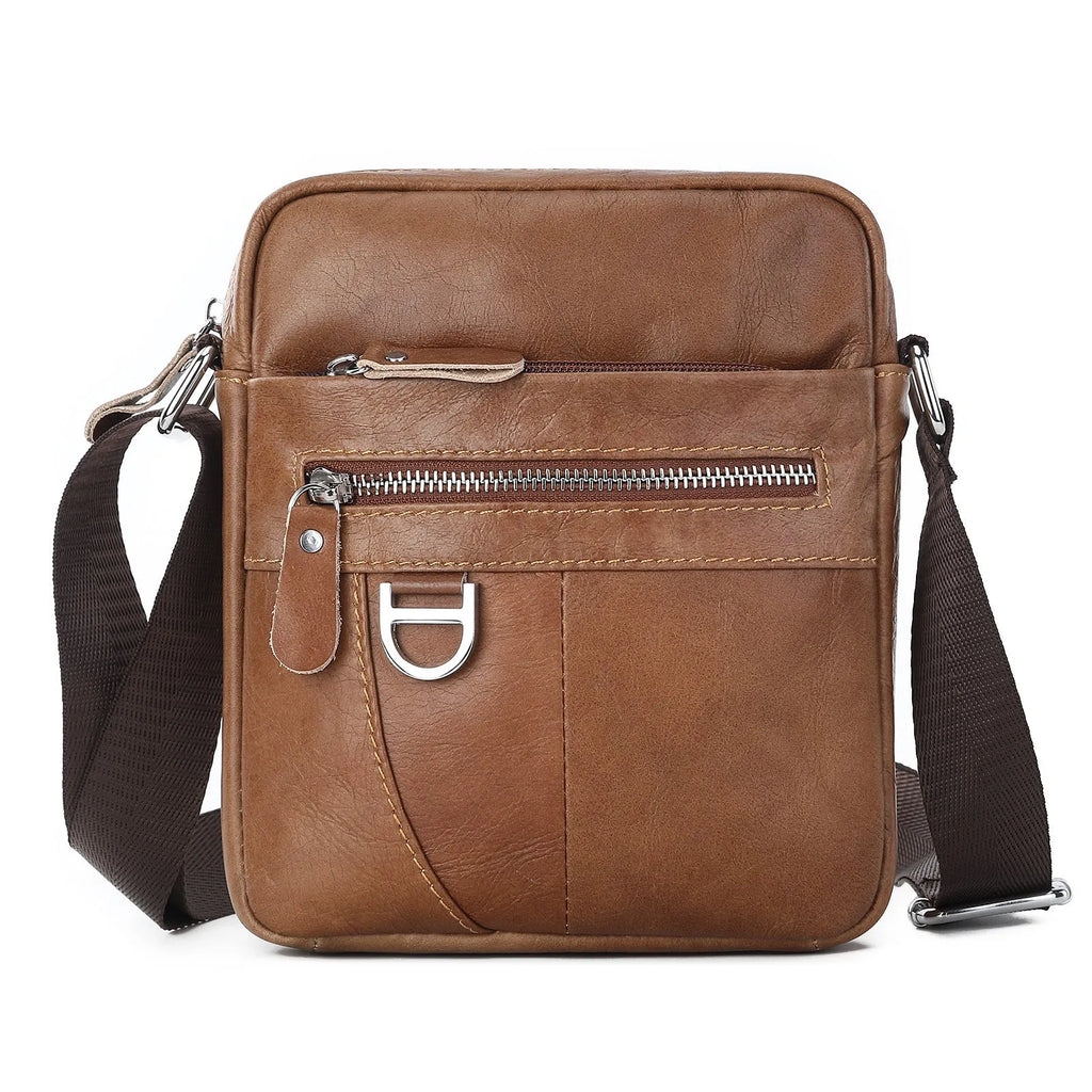 Retro brown leather messenger bag with crossbody strap on a table.