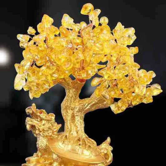 Citrine coloured small water turtle money tree resin ornament on a white background.
