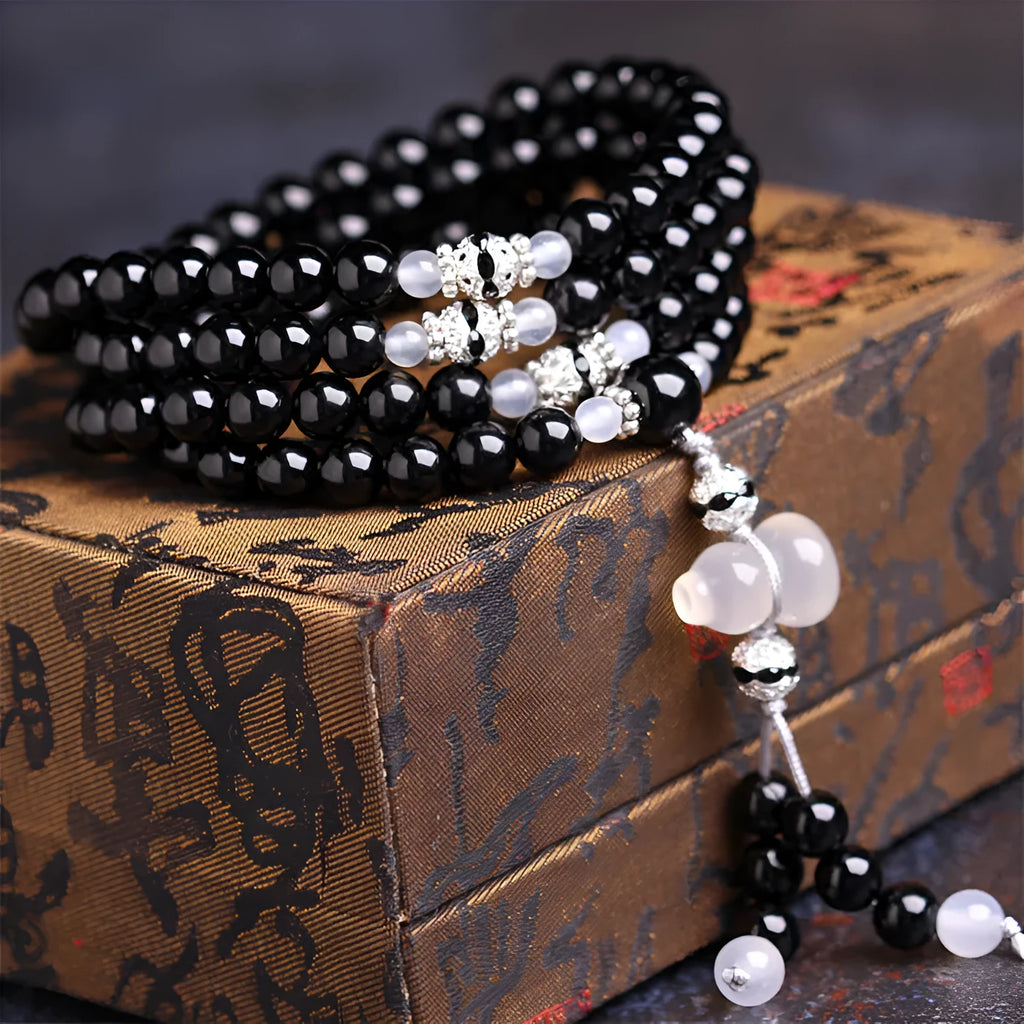 Black agate bracelet with 108 geometric natural stone beads on adjustable fastening