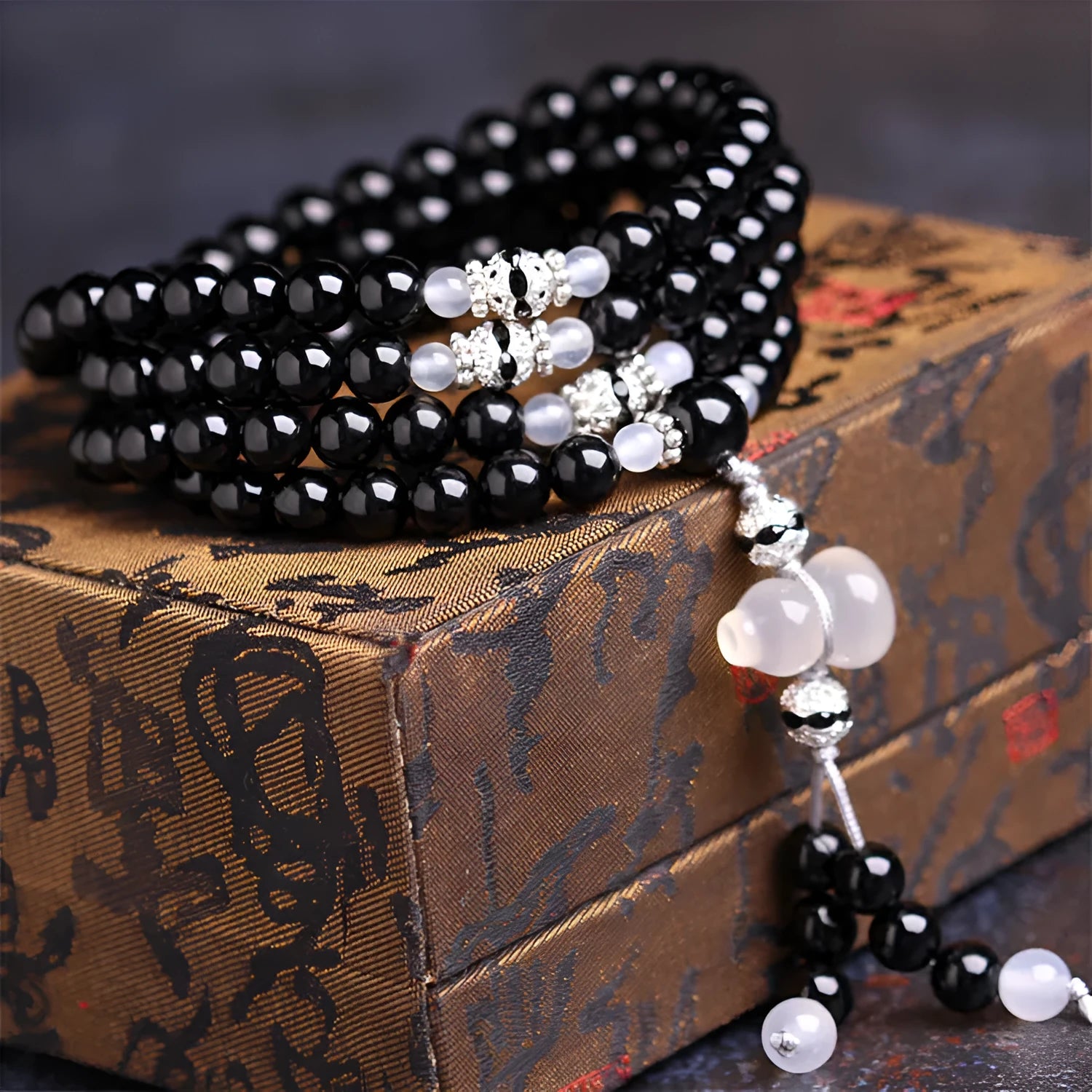 Black agate bracelet with 108 geometric natural stone beads on adjustable fastening