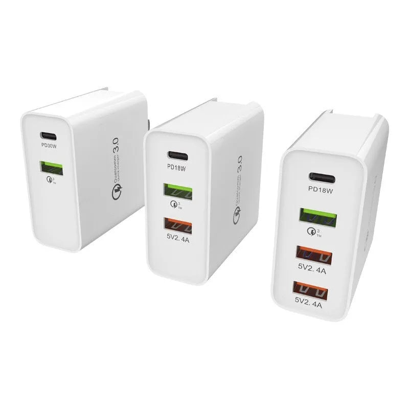 White fast charge wall charger with multiple USB ports on a table.