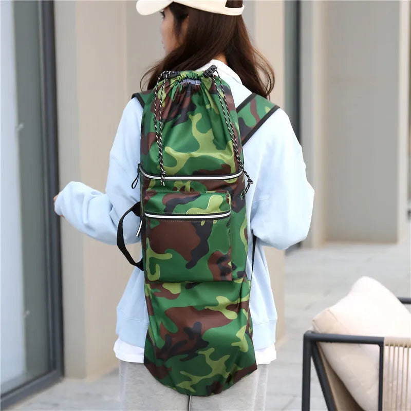 Black waterproof nylon skateboard duffel bag with long main compartment for a 90cm board or fishing rods.