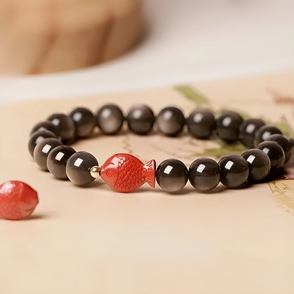 Natural obsidian bracelet with cinnabar fungal growth in round beads, showing stone patterns