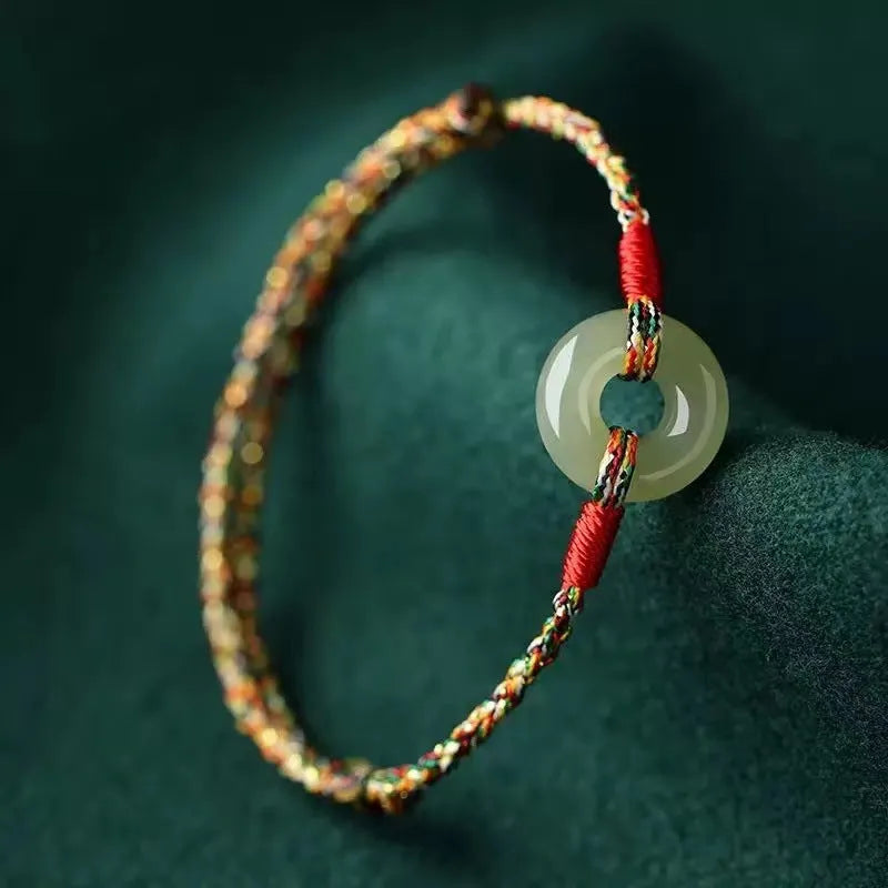 Colourful woven rope bracelet with silver peace buckle closure on wrist