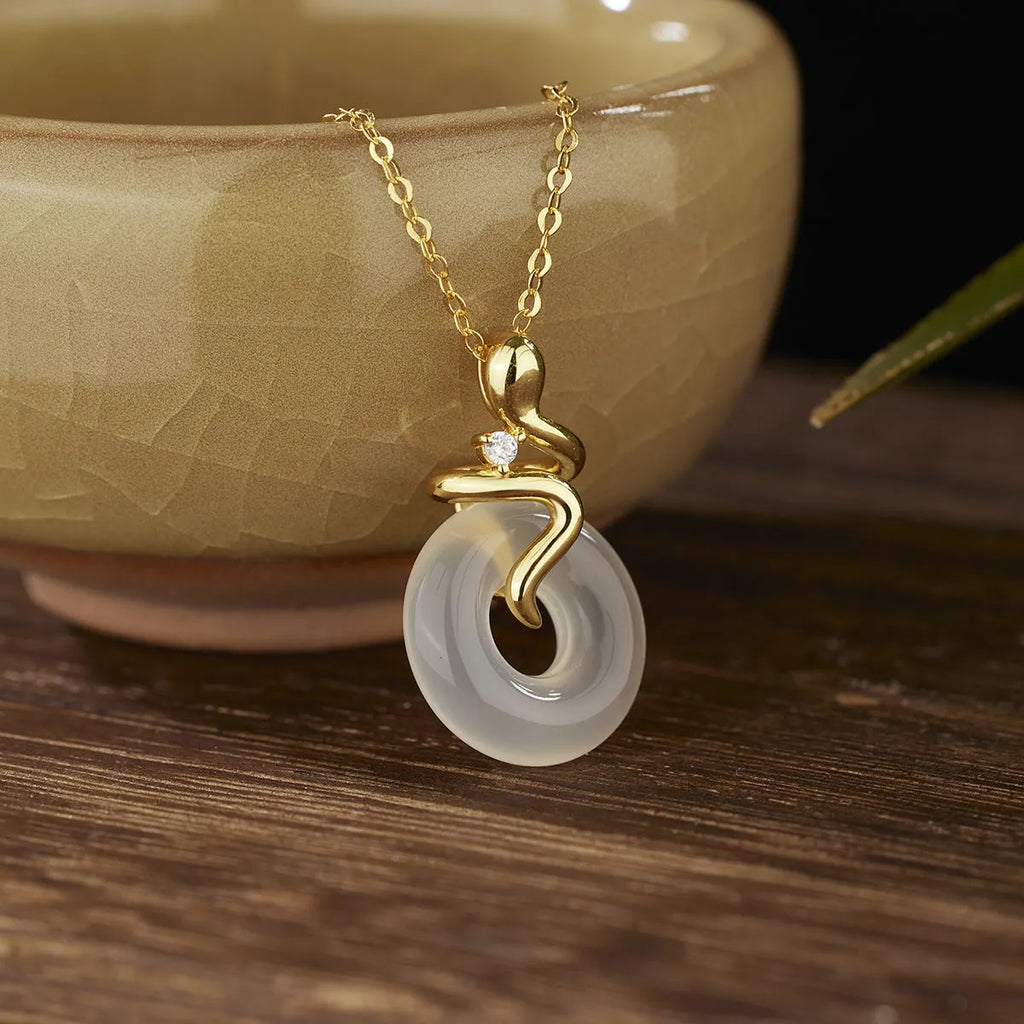 Women's sterling silver snake necklace with white jade inlay pendant on cross chain
