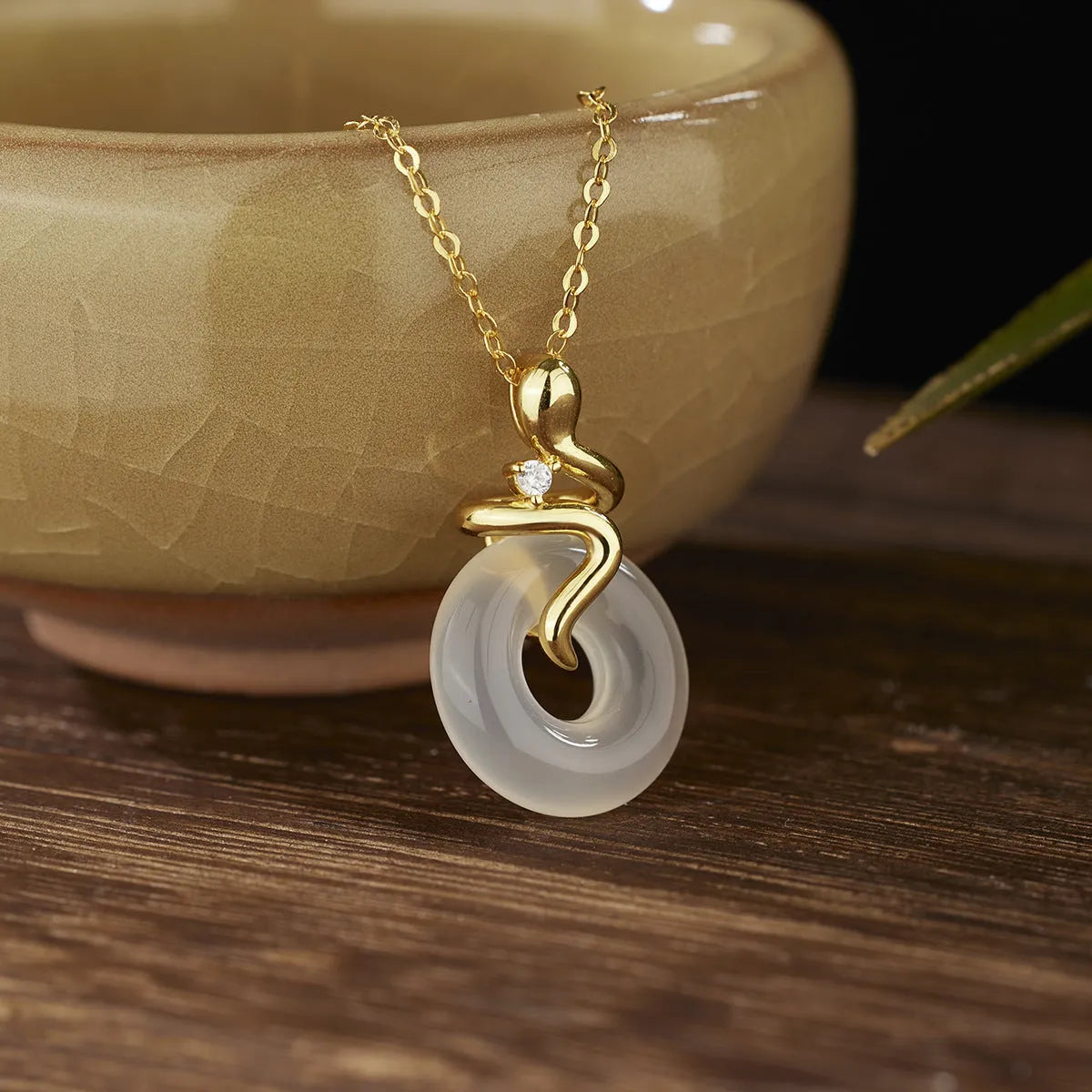 Women's sterling silver snake necklace with white jade inlay pendant on cross chain