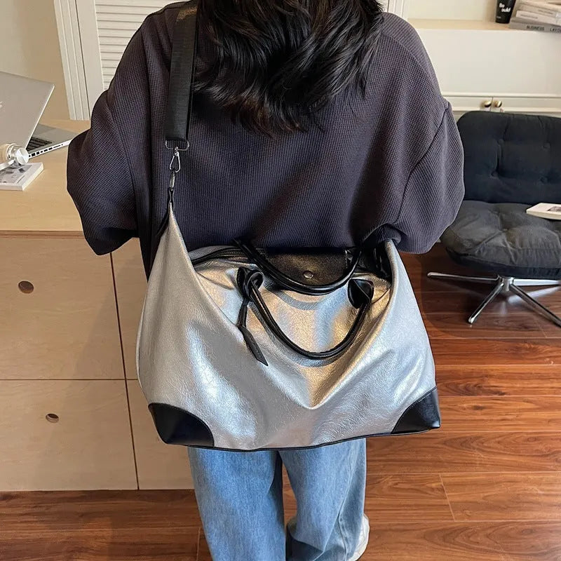 Large hand-carry travel bag for women in black colour showing storage capacity