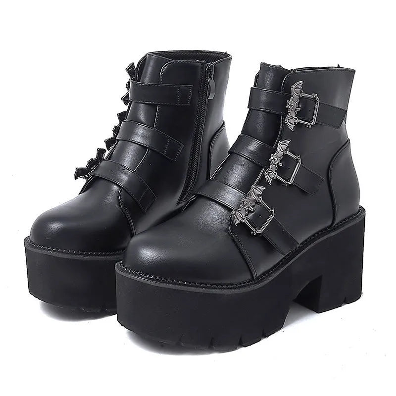 Black women's ankle boots with bat buckle, side zip, and thick heel.
