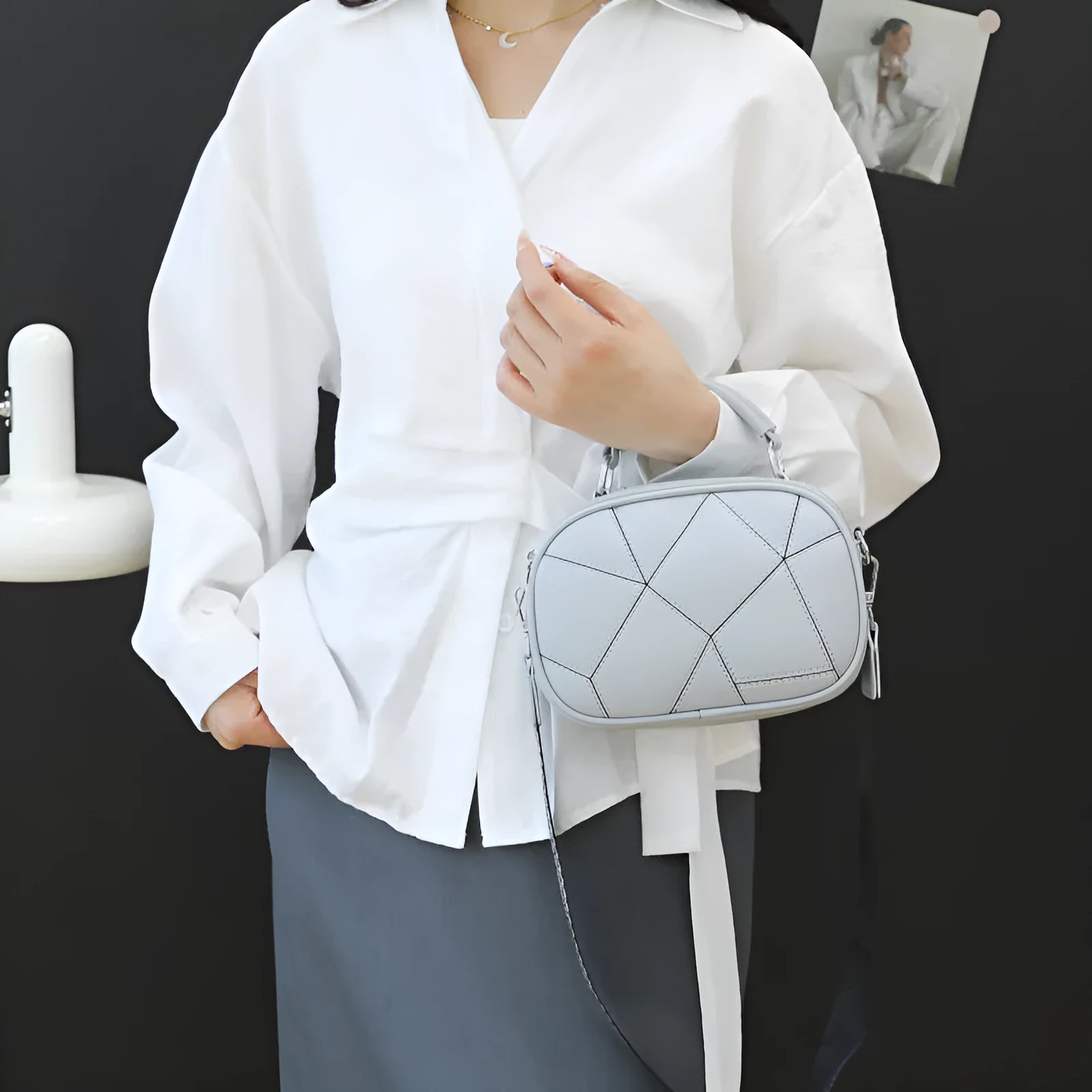 Round PU leather crossbody bag with patchwork design showing decorative stitching