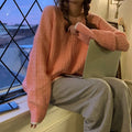 A woman's loose-fit solid colour pullover sweater in lake blue, made from polyester fibre.