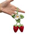 Handmade woven strawberry-shaped car pendant made from cotton and hemp yarn.