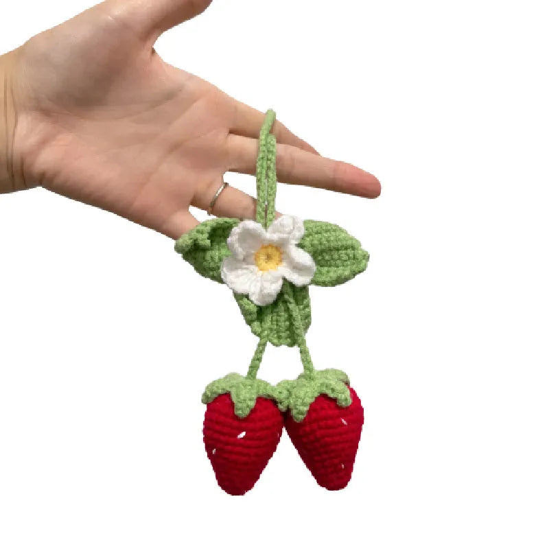 Handmade woven strawberry-shaped car pendant made from cotton and hemp yarn.