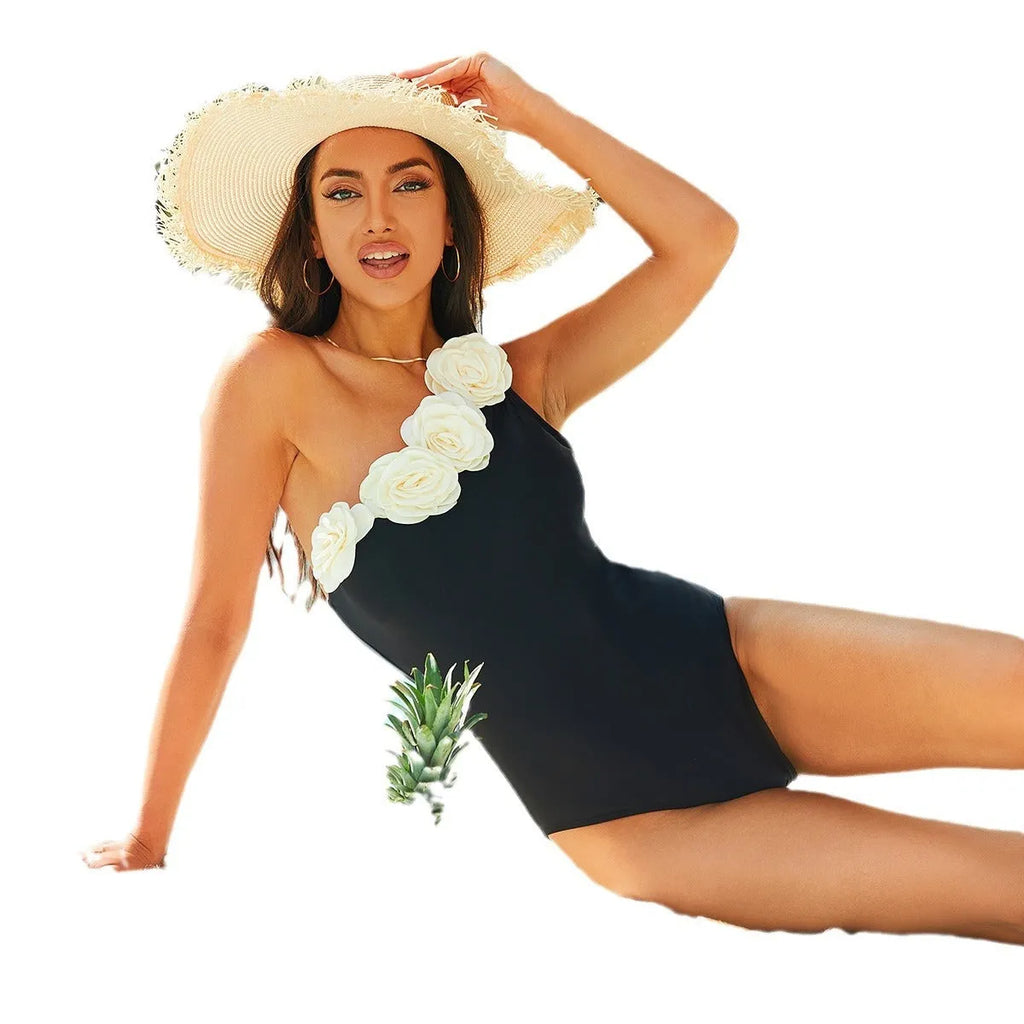 Black solid colour one-piece swimsuit for women on a hanger.