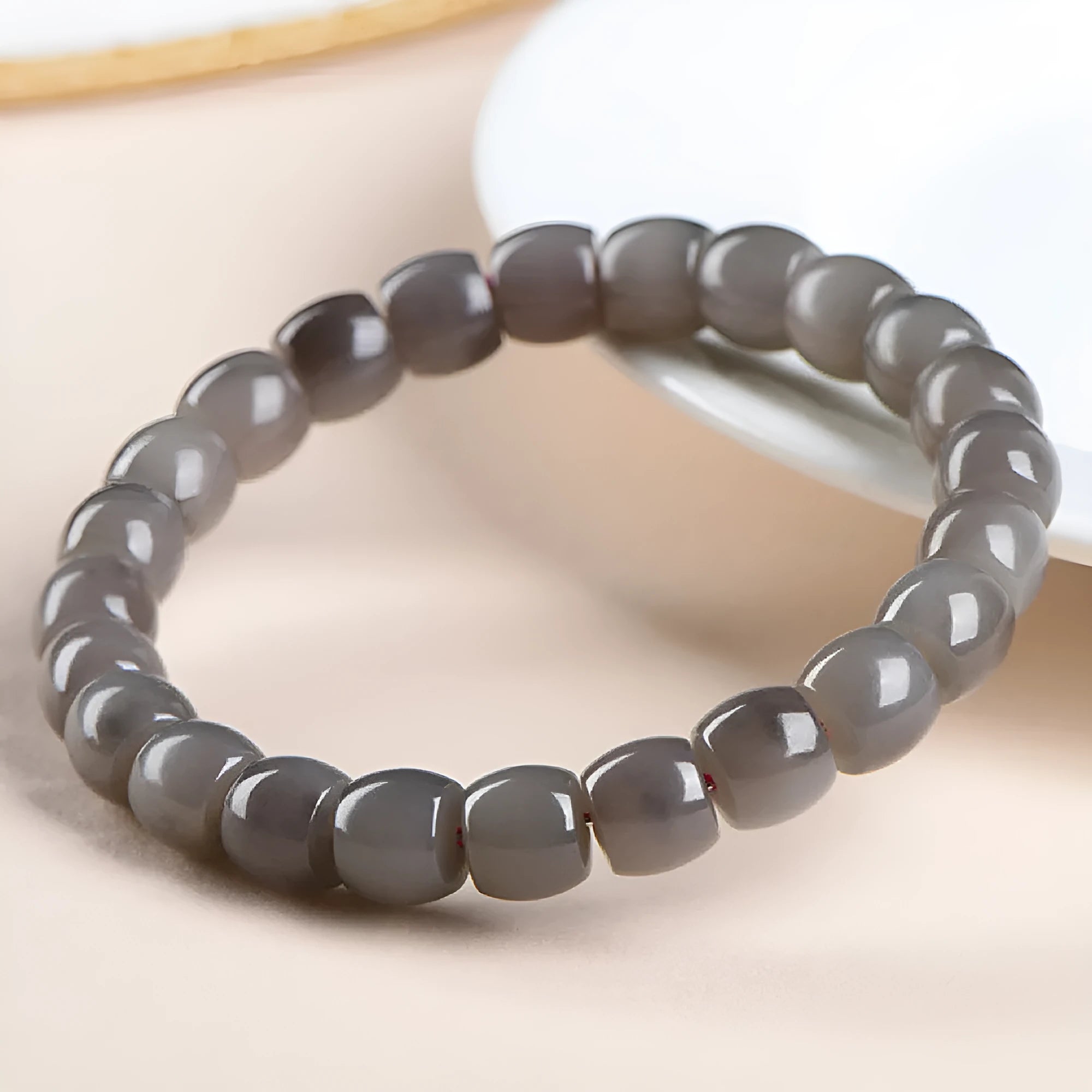 Straight cut smokey violet Hetian jade bracelet with approximately 24 beads, each measuring 8mm by 9mm.