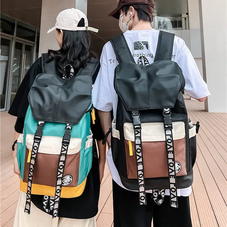 Oxford cloth backpack in black shown with handheld grip and shoulder straps.