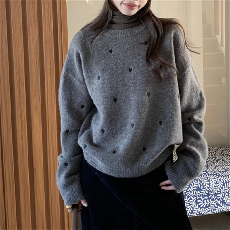Women's loose acrylic pullover sweater with embroidered love pattern in beige, long sleeves and crew neck.