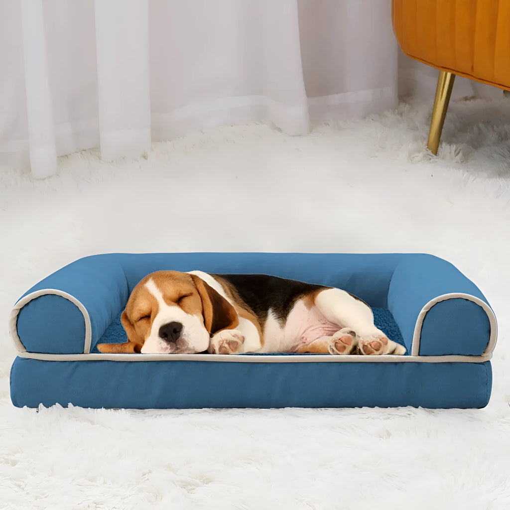 A dark grey, rectangular sponge dog bed with a removable cloth cover, shown inside a metal wire crate.