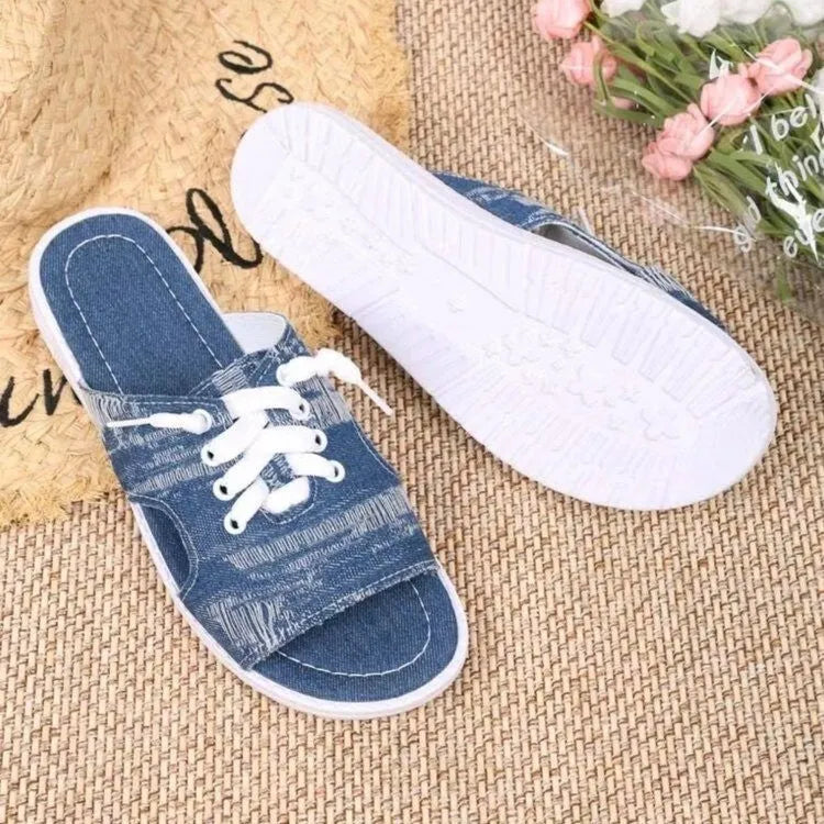 Blue women's Roman style flat canvas slippers with a rubber sole.