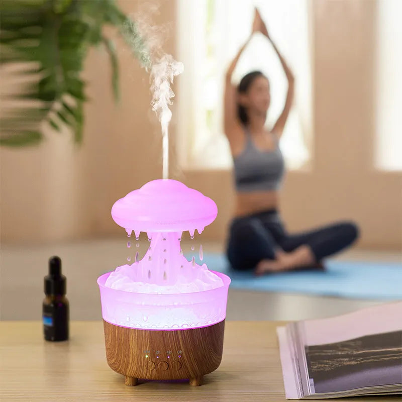 Wood grain white rain cloud humidifier diffuser with glowing LED light and water droplets.