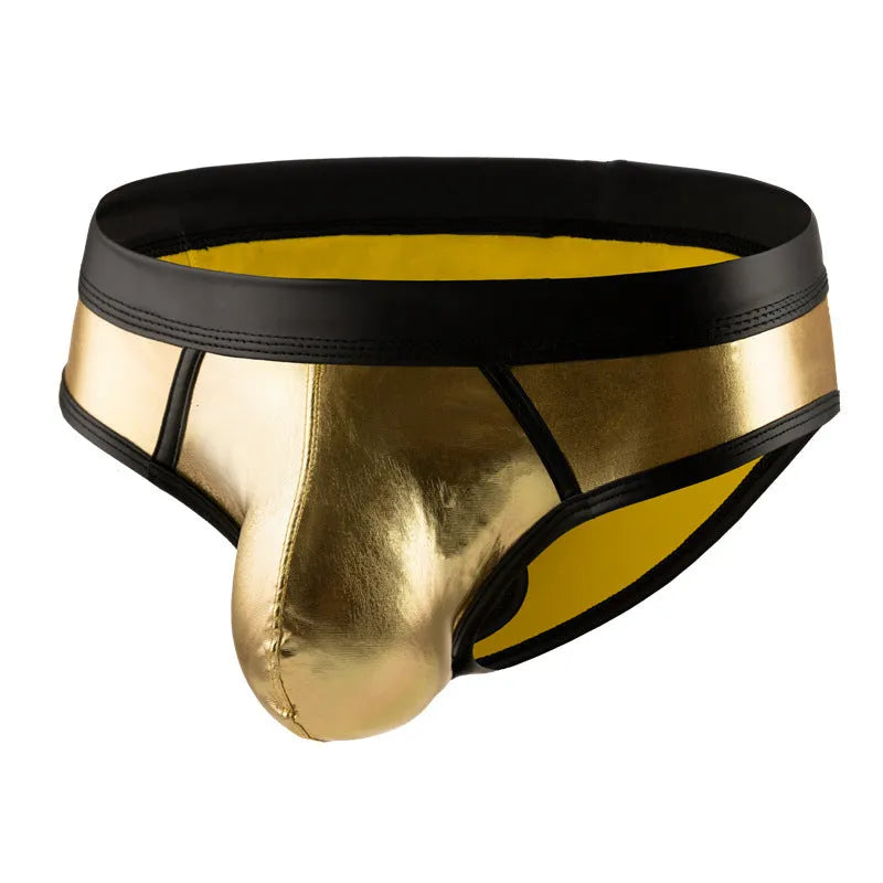Man wearing low-waist gold bikini swim briefs on beach