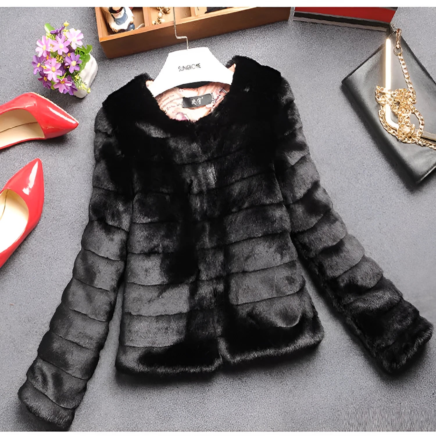 Women's short-length faux fur top in beige, shown with regular sleeves, on a model.
