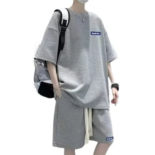 Men's waffle texture leisure set comprising a grey short-sleeve T-shirt and matching shorts on a hanger.