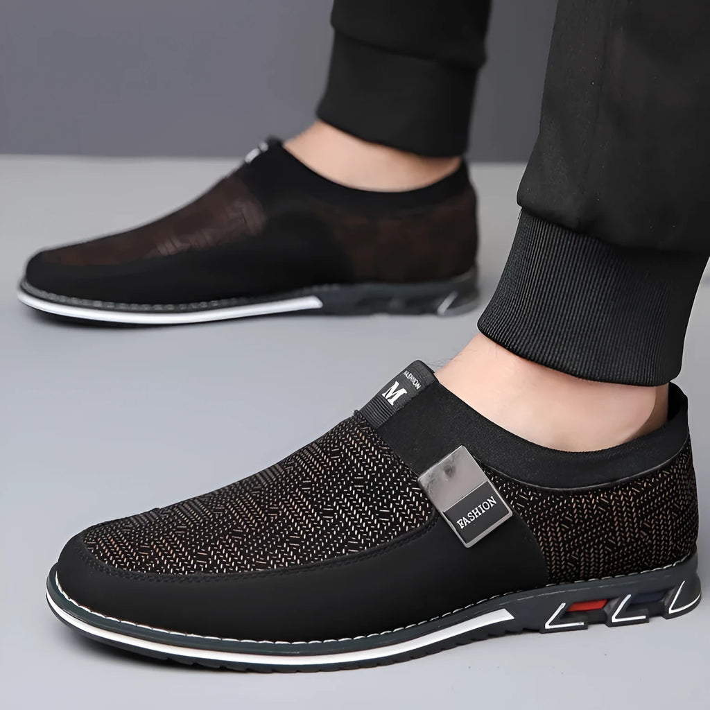 Men's grey and white synthetic leather slip-on loafers with a square toe and flat rubber sole.