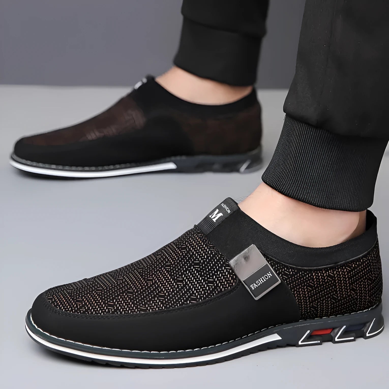Men's grey and white synthetic leather slip-on loafers with a square toe and flat rubber sole.
