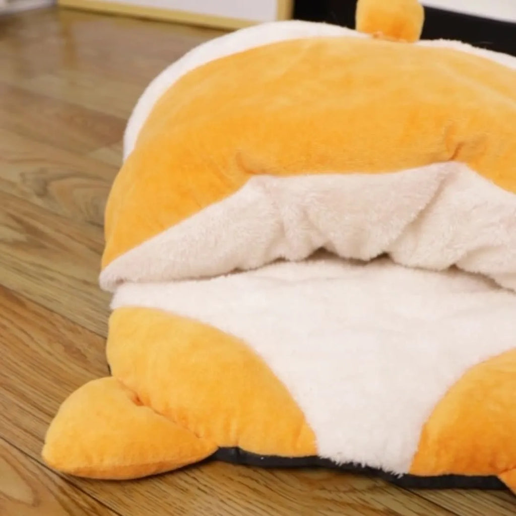 Orange semi-closed cat sleeping bag bed showing soft nest construction and raised edges.