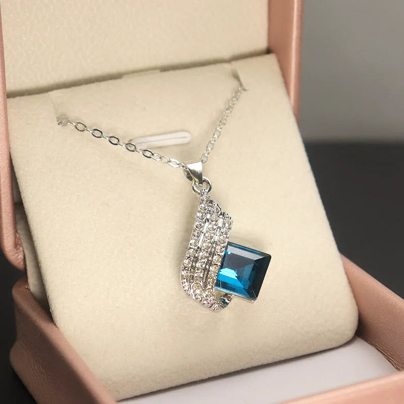 Silver-tone cross chain necklace and matching earring set with glass pendant details