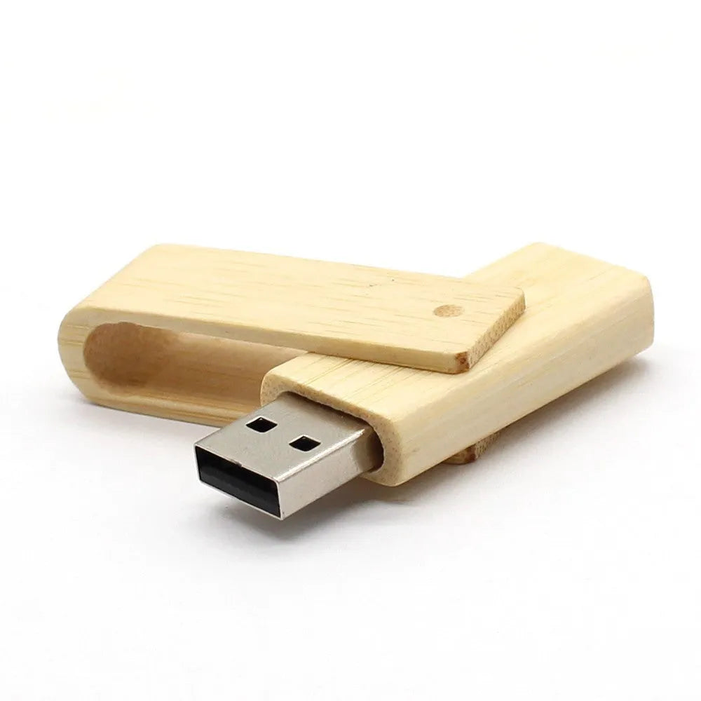 Pink wooden USB flash drive with rotating clip on a light background showing its natural wood grain and compact size
