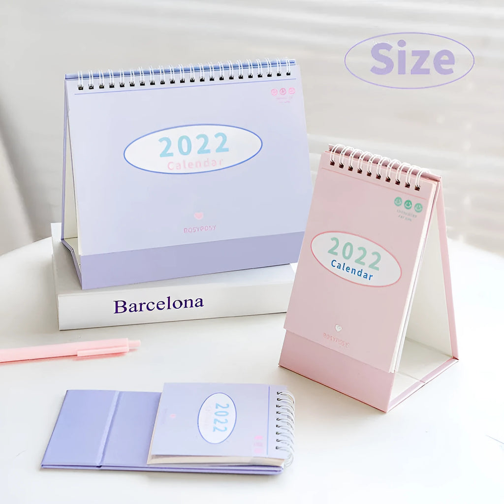 Cream coil desk calendar on a table, regular size 100mm, paper material with year-round date layout