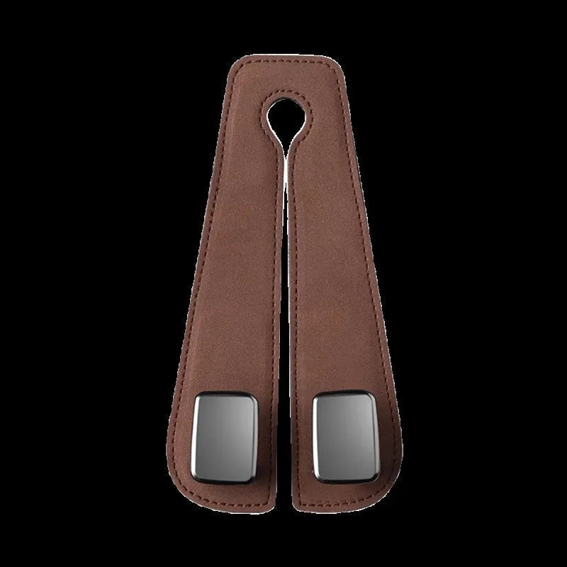 Black alloy car seat hook with suede covering attached to a grey car seatback.