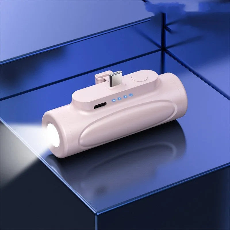 Black Creative Power Bank Glare Flashlight showing LED light on and compact 83mm size next to a mobile phone.