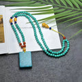 Turquoise stone mesh flower pendant on an adjustable ball bead necklace chain.