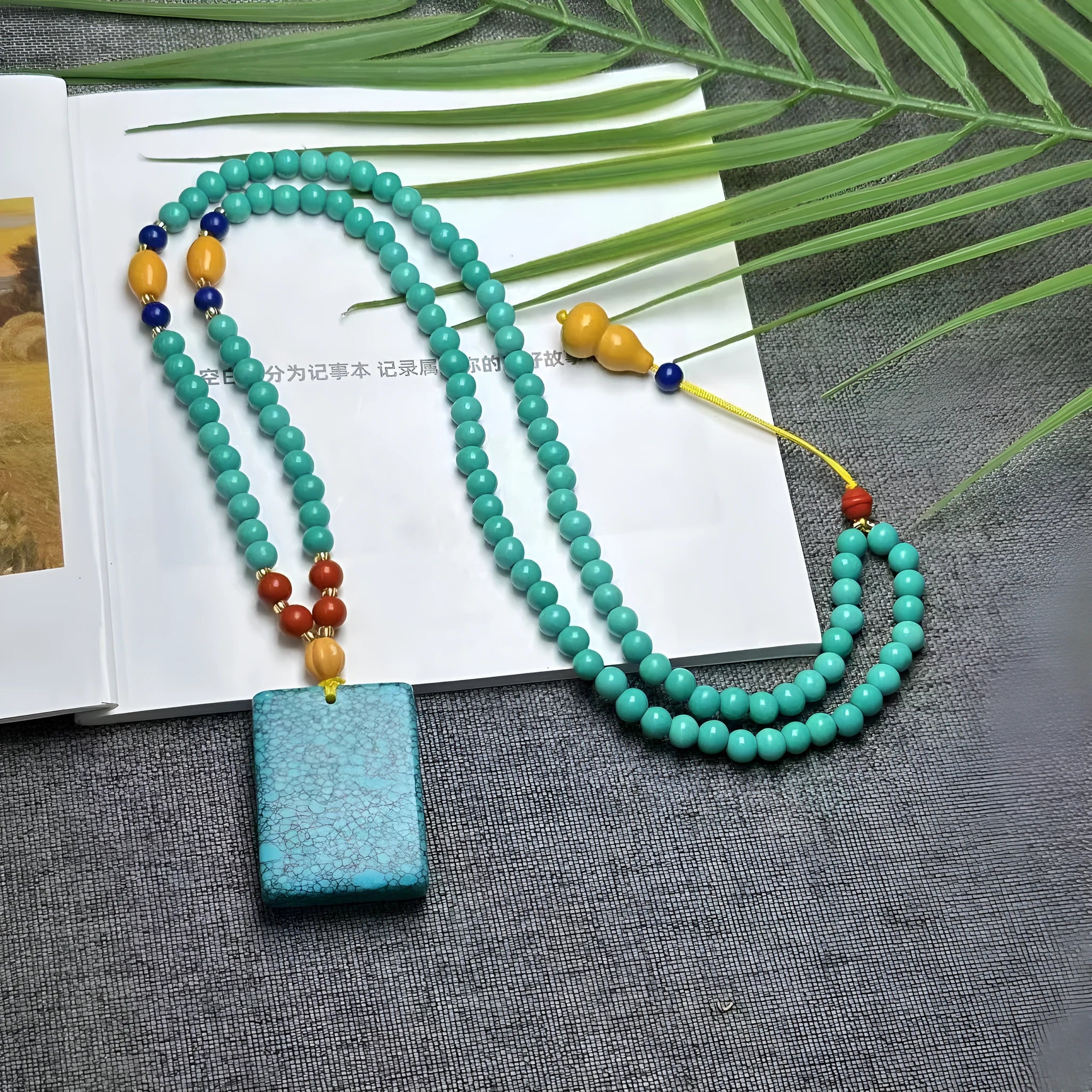 Turquoise stone mesh flower pendant on an adjustable ball bead necklace chain.
