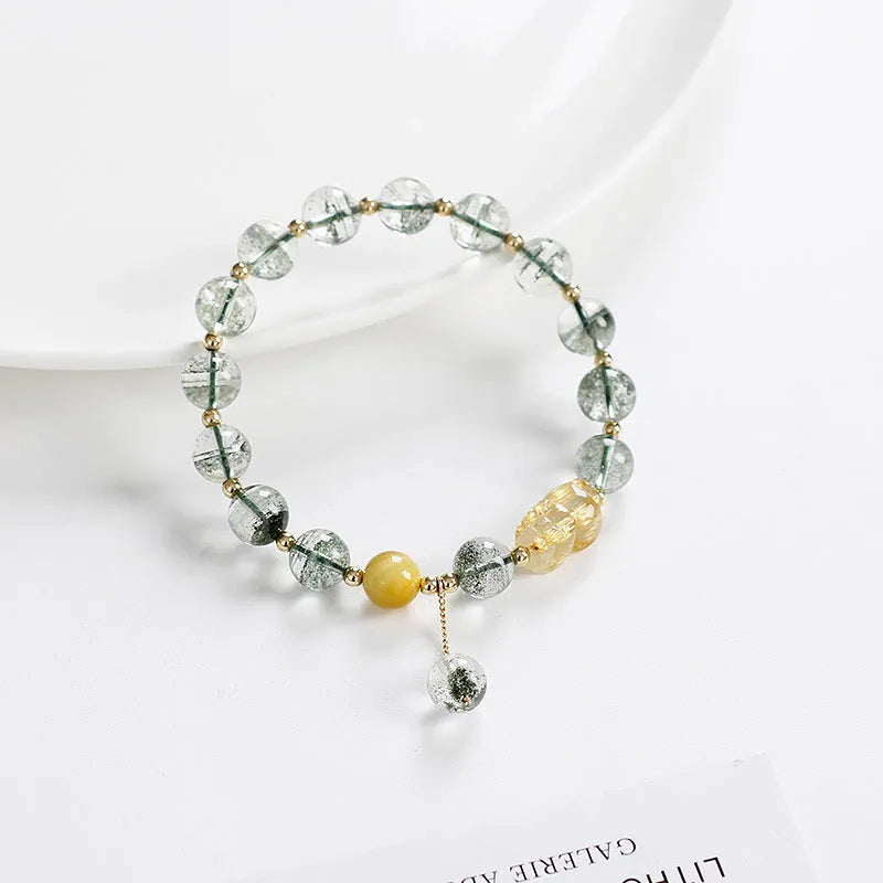 Green phantom quartz crystal bracelet with rutilated inclusions, geometric ethnic design, 8mm diameter