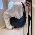 Women's retro dumpling-shaped PU shoulder bag in cream yellow with a zippered compartment.