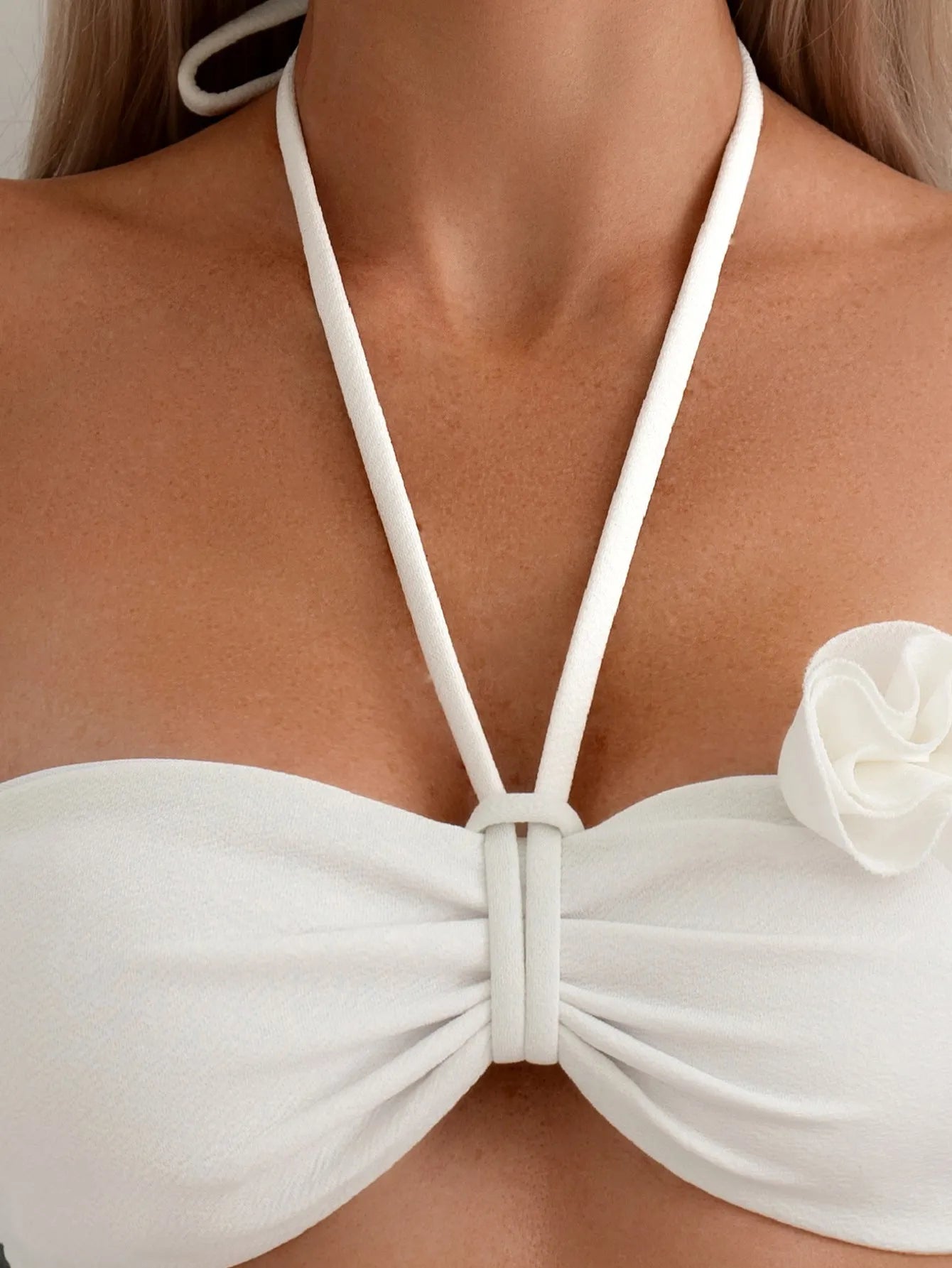 White halter neck lace-up swimsuit bikini with three-dimensional flower pattern.