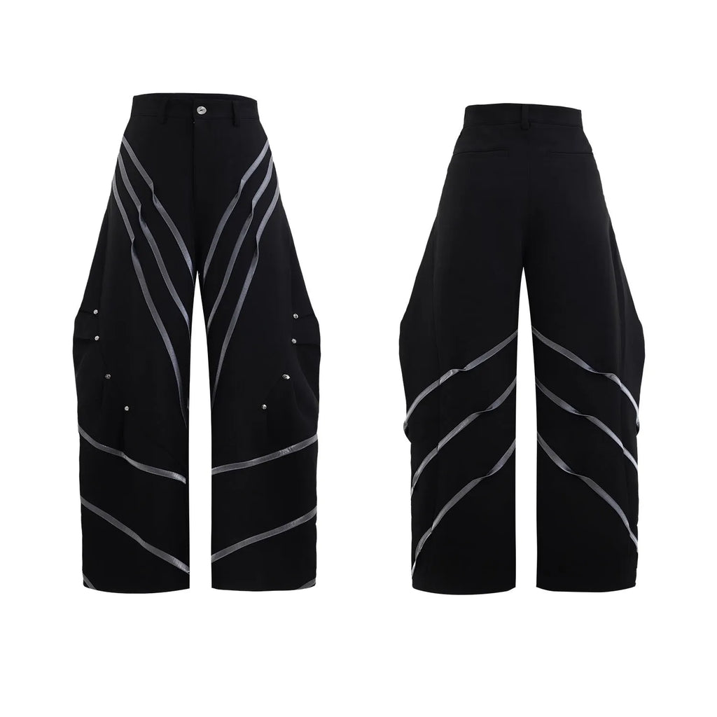 Men's black and white polyester trousers with 3D cutting, metal rivet stripes, and pleated front.