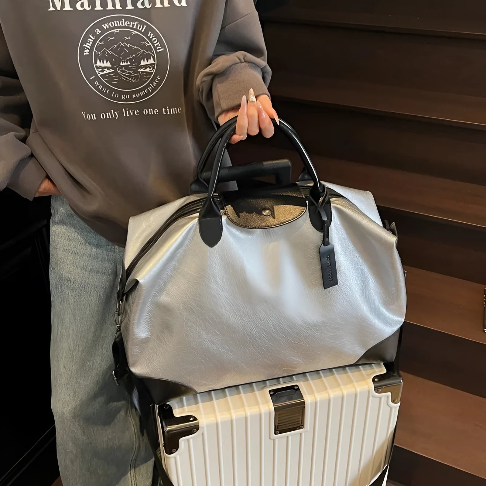 Large hand-carry travel bag for women in black colour showing storage capacity