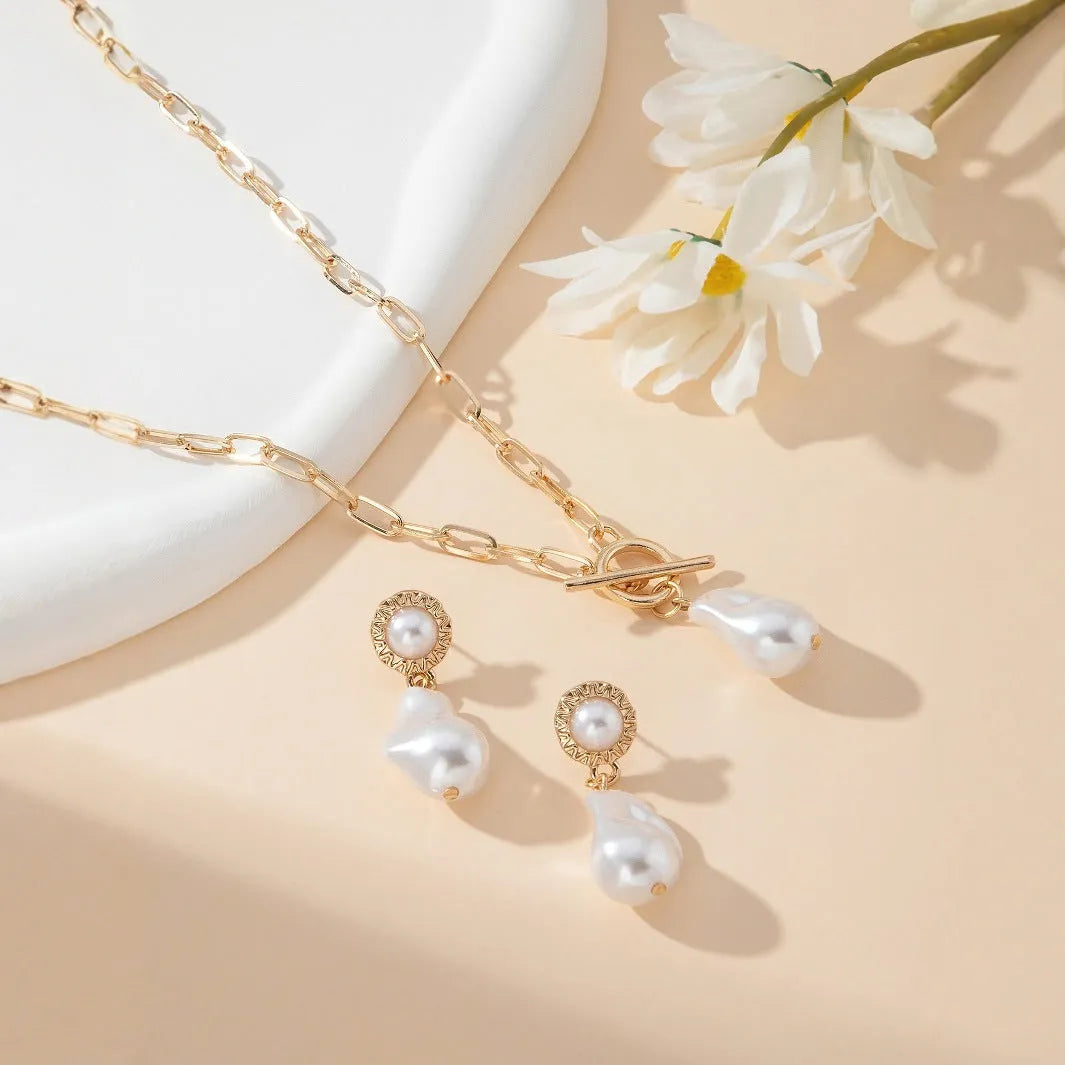 Gold colour baroque pearl pendant necklace and matching stud earrings set.