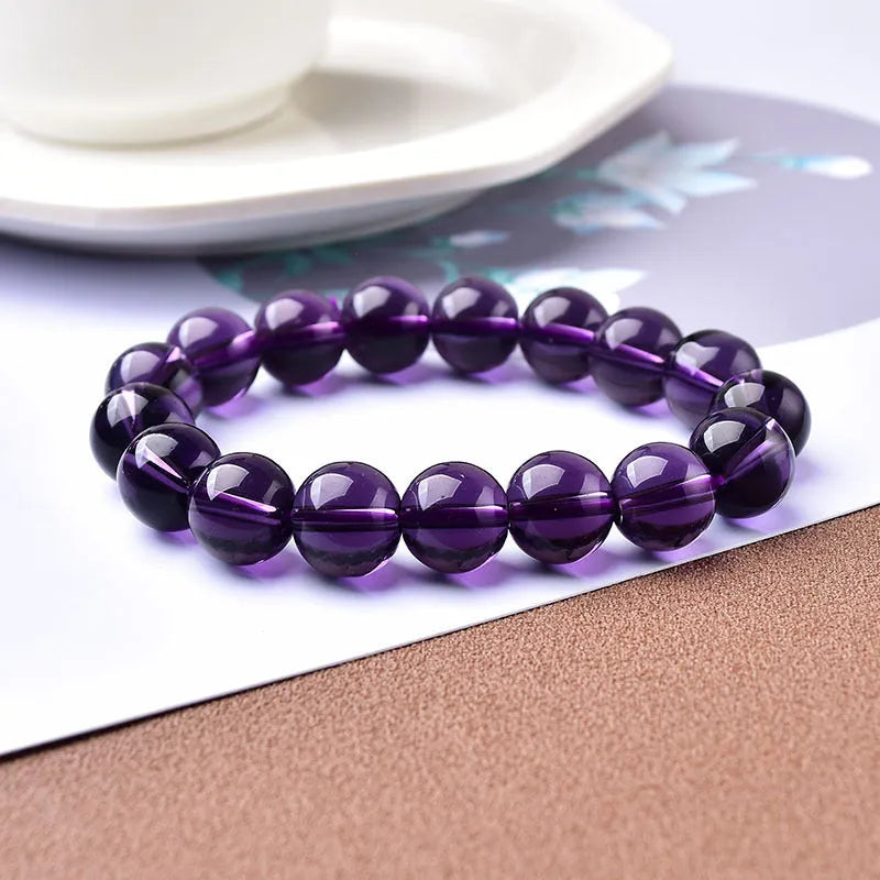 Geometric glass bead bracelet in obsidian, amethyst, citrine, or white crystal on a white background.
