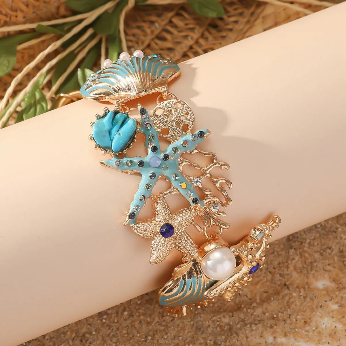 Women's alloy rhinestone nautical bracelet with starfish and anchor charms in turquoise, red, or blue.