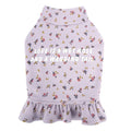 Teddy bichon dog wearing light purple undershirt and matching floral skirt pet clothing