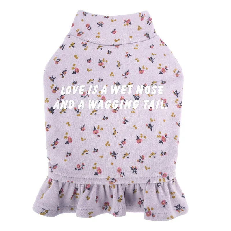 Teddy bichon dog wearing light purple undershirt and matching floral skirt pet clothing